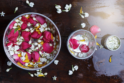 Water jasmine and rose petals in silver bowl with colorful flowers for Songkran festival, Thailand,Vintage
