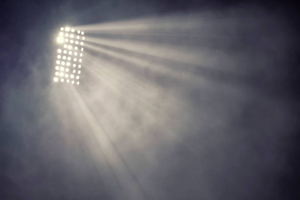 istock stadium lights and smoke against dark night sky background 1199913121