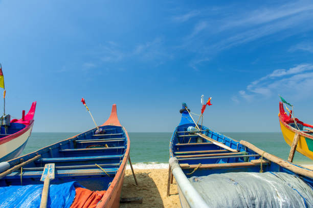 Fishing boats on the Varkala beach in south india Colorful fishing boats on the Varkala beach on sunset Kerala, India kerala south india stock pictures, royalty-free photos & images