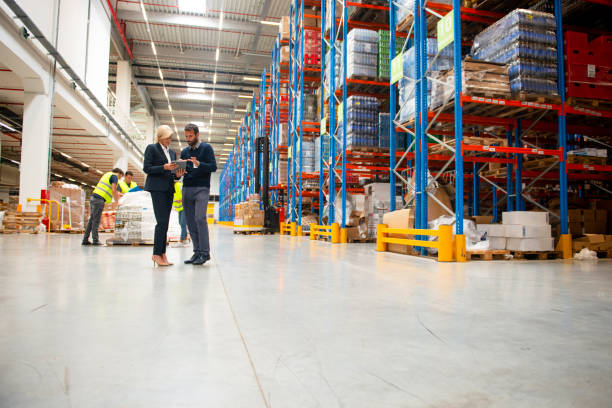 istock Managers in Warehouse discuss about business strategy 1199917860