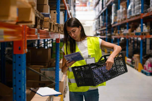 istock Workers in warehouse review the goods 1199917908