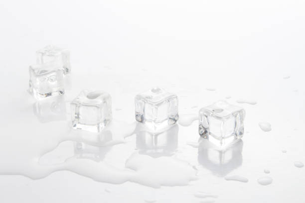 istock Cubes of ice and spilled water on a light background 1199919453