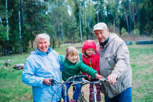 istock active senior couple with kids riding bikes in nature 1199919629