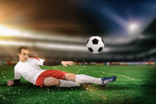 istock Composite image of football player in white kicking 1199919680