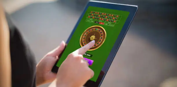 Online Roulette Game  against businesswoman using digital tablet