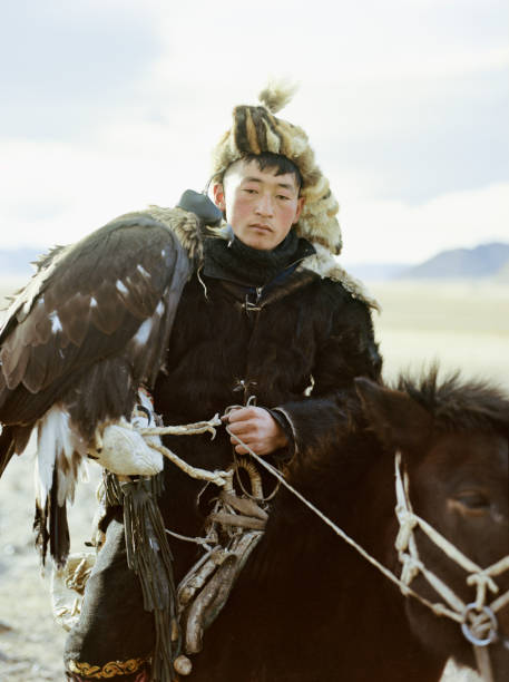 istock Portrait of eagle hunter on horse in desert in Mongolia 1199923556