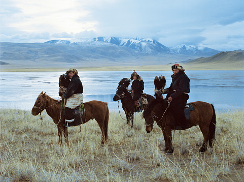Eagle hunters, on their horses, gathering at the opening ceremony of the Sagsai Golden Eagle Festival, held on 17th-18th September 2023, near the small town of Sagsai, in the Bayan-Ulgii province of Western Mongolia. Set in the Altai Mountain range, the nomadic eagle hunters, dressed in traditional fur and embroidered clothing, gather to compete with their eagles, in various competitions that show the skill and bond between the hunter and their eagle.