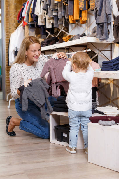 istock Mother and daughter choosing baby clothes 1199924744