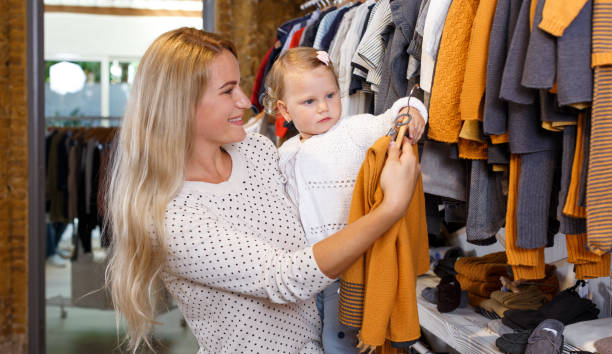 istock Mother and daughter choosing baby clothes 1199924745