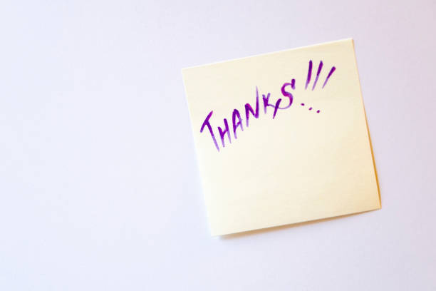 istock Sticker on a white wall with the message: Thanks. Concept, message of thanks. 1199924887