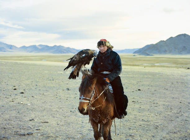istock Portrait of eagle hunter on horse in desert in Mongolia 1199925281