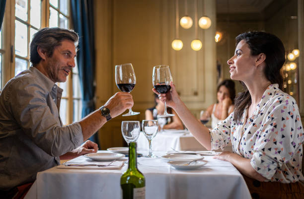 istock Celebrating couple enjoying wine at a restaurant 1199926385