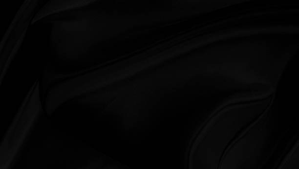 istock Black gray satin dark fabric texture luxurious shiny that is abstract silk cloth background with patterns soft waves blur beautiful. 1199926903