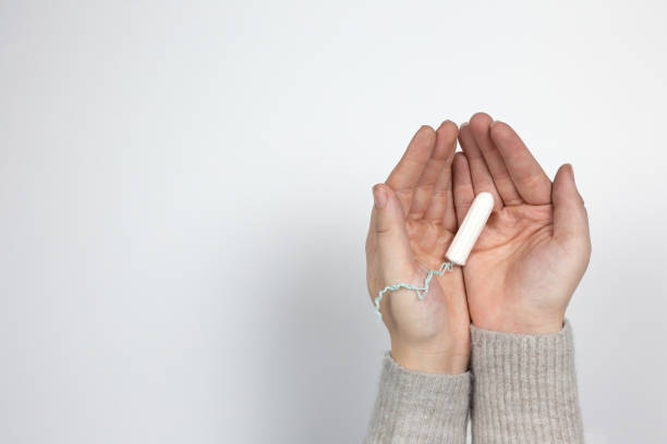 istock White clean tampon on woman's hand isolated on a white background. Menstruation time. Hygiene and protection. 1199930940