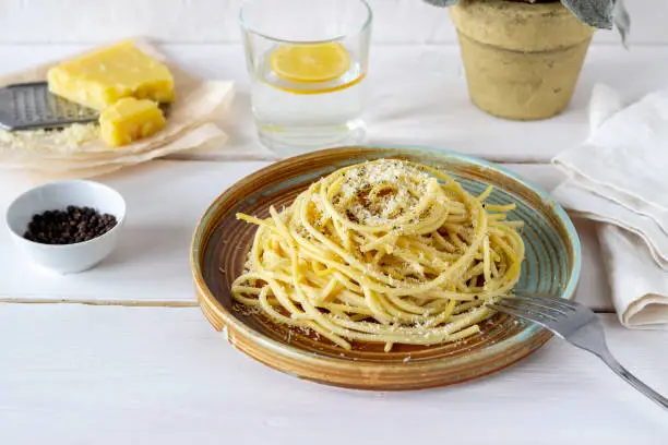 Roman pasta spaghetti with black pepper and cheese. Cacio e pepe. Recipes. Vegetarian food. National cuisine. White background.