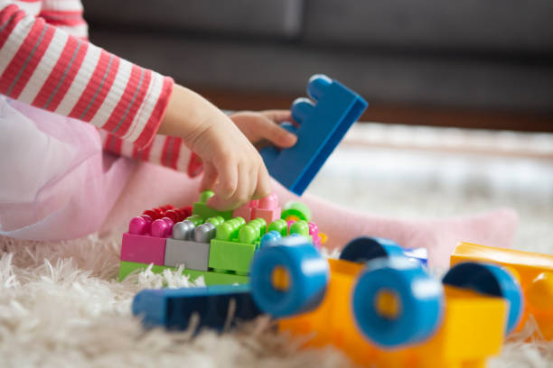 istock Little girl playing with toy blocks 1199931987