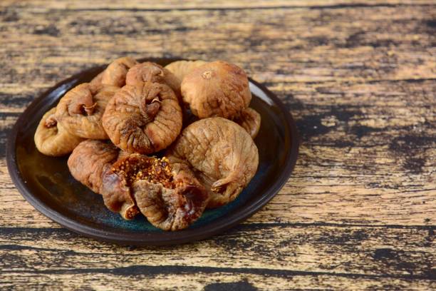 istock Dried figs on wooden background 1199935132