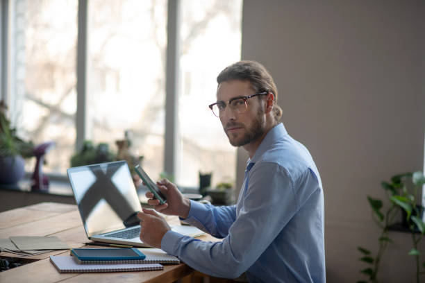 istock Young successful man sitting at the office with a laptop. 1199935299