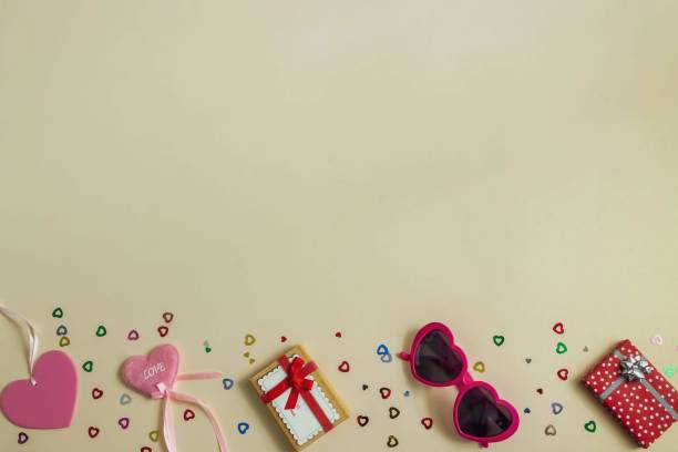 istock Heart-shaped glasses, gift boxes and hearts on a light background 1199937429
