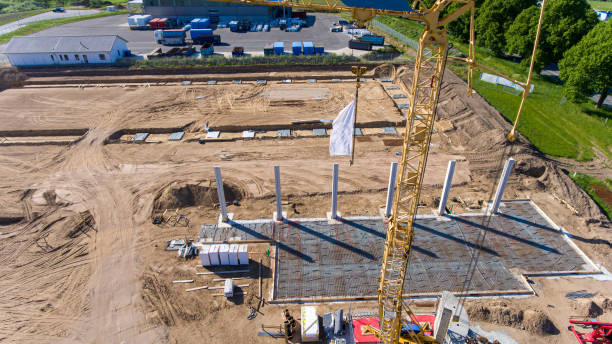 istock Drone photos of a large construction site on which a factory building is being erected. The foundations for the piers have been laid and and the first piers have been erected 1199940021