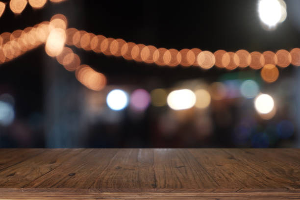 istock Empty wooden table in front of abstract blurred night light in cafe, restaurant. 1199942427