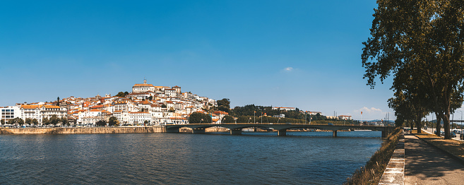 wide panoramic view on historic Town of Coimbra upon the river