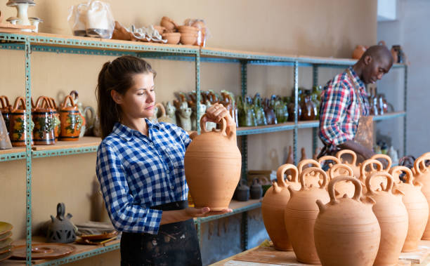 istock Two positive smiling potters in the process of work at the workshop 1199943820