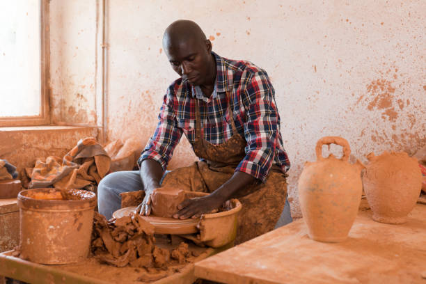 istock Man making ceramics on pottery wheel 1199944372