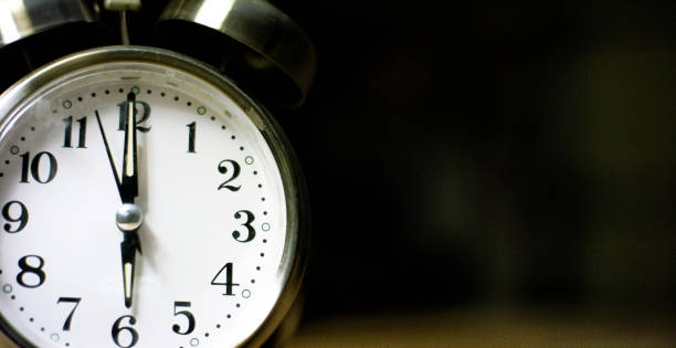 istock A Silver-Colored, Metal, Retro-Style, Analog Alarm Clock at 6:00 1199944893