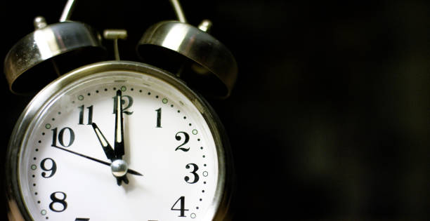 istock A Silver-Colored, Metal, Retro-Style, Analog Alarm Clock at 11:00 1199944936