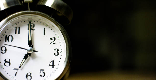 istock A Silver-Colored, Metal, Retro-Style, Analog Alarm Clock at 7:00 1199944937