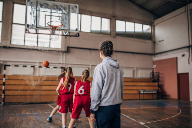 istock Female coach with basketball team 1199946590