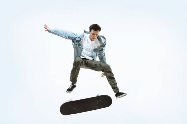 istock Caucasian young skateboarder riding isolated on a white background 1199948926