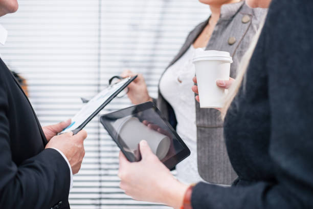 istock close up. group of employees discussing current tasks. 1199948937