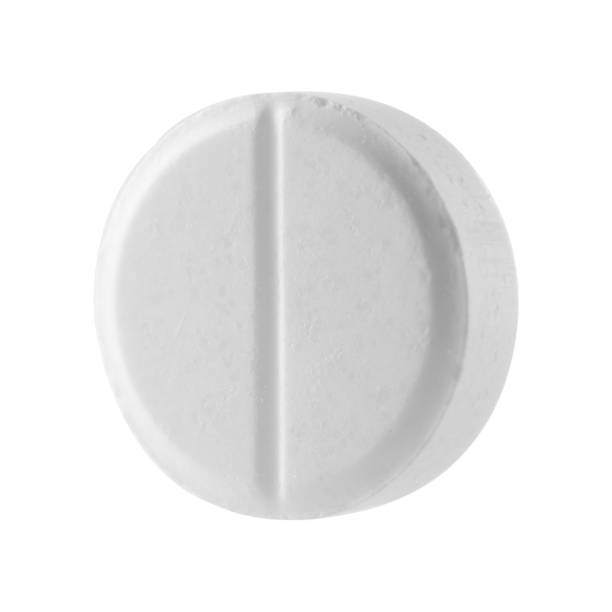 istock White round pill on a white isolated background. Big pill close-up. 1199948959