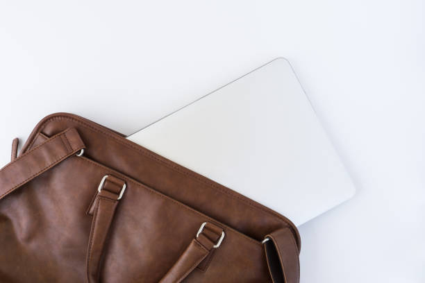 istock Brown business leather briefcase with notebook isolated background 1199951078