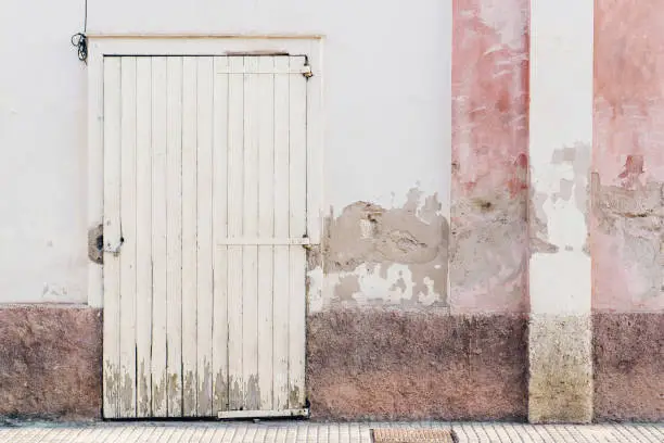 House grunge facade pink white wooden door