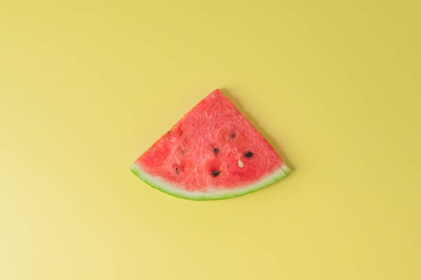 istock Watermelon piece on creative yellow background 1199951158