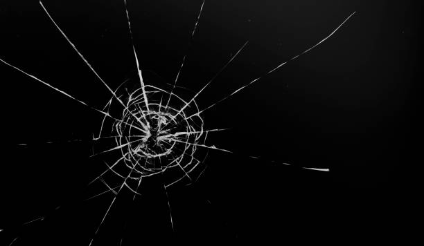 istock Round white cracks in glass on black background. 1199951349