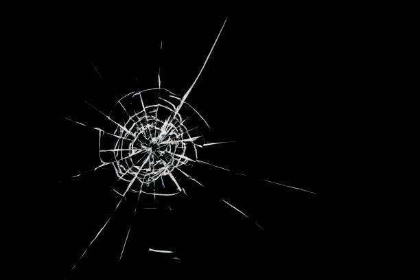 istock Round white cracks in glass on black background. 1199951350