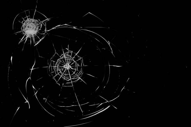 istock Round white cracks in glass on black background. 1199951356
