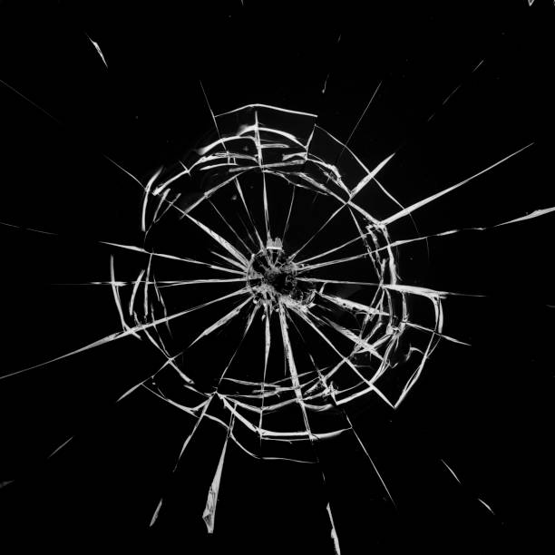 istock Round white cracks in glass on black background. 1199951357