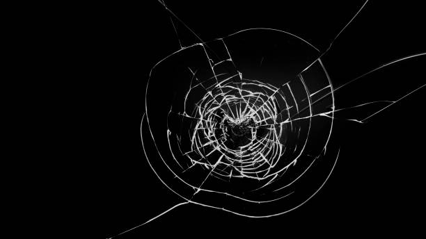istock Round white cracks in glass on black background. 1199951359