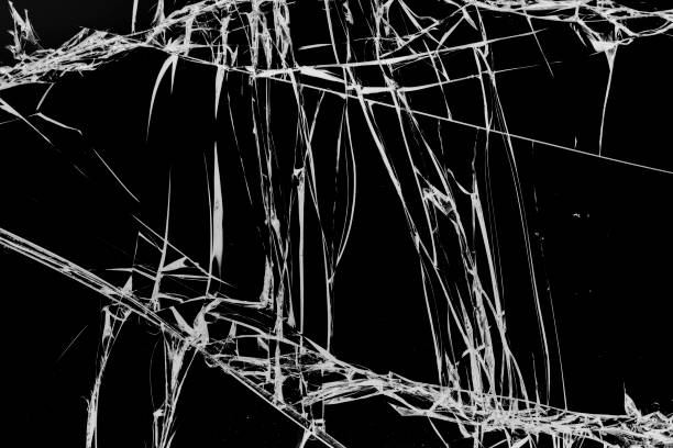 istock Chaotic cracks in glass on black background 1199951368