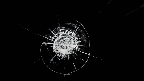 istock Round white cracks in glass on black background. 1199951378