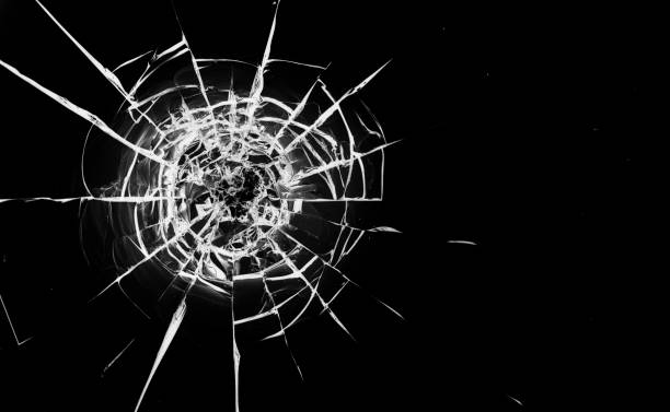 istock Round white cracks in glass on black background. 1199951391
