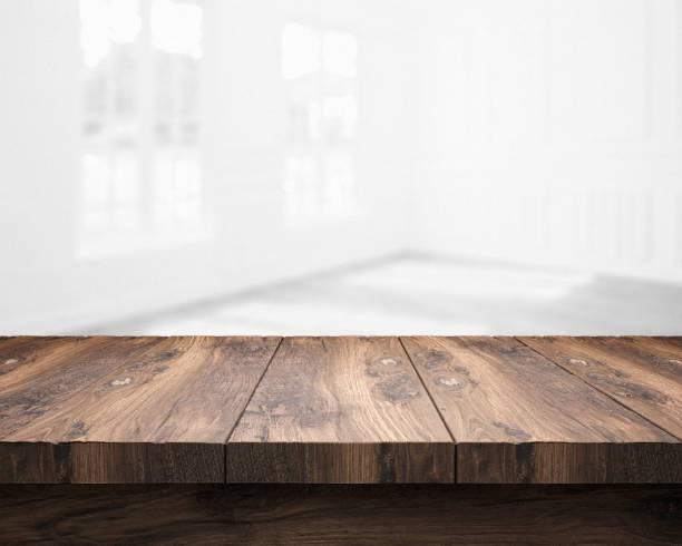 istock rustic blank wooden table top in front of blurry room 1199952879