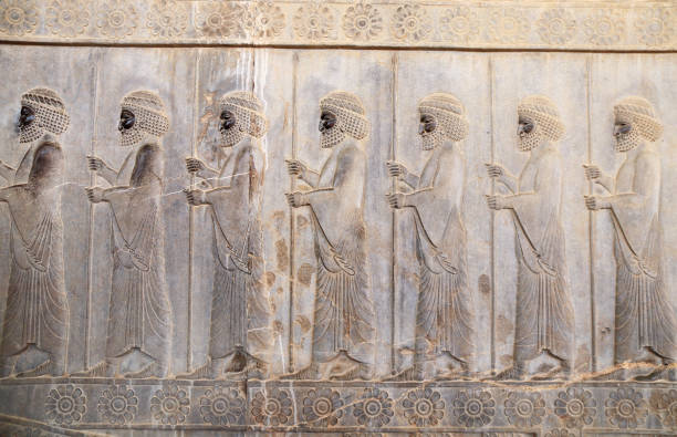 Ancient wall with bas-relief with assyrian warriors with spears, Persepolis, Iran. UNESCO world heritage site