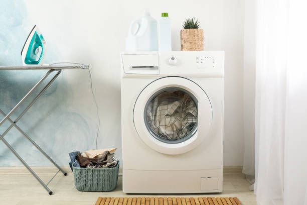 istock Laundry room with washing machine against light blue wall 1199955126