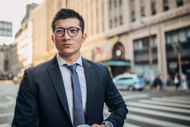 istock Handsome businessman is walking on the street 1199955281